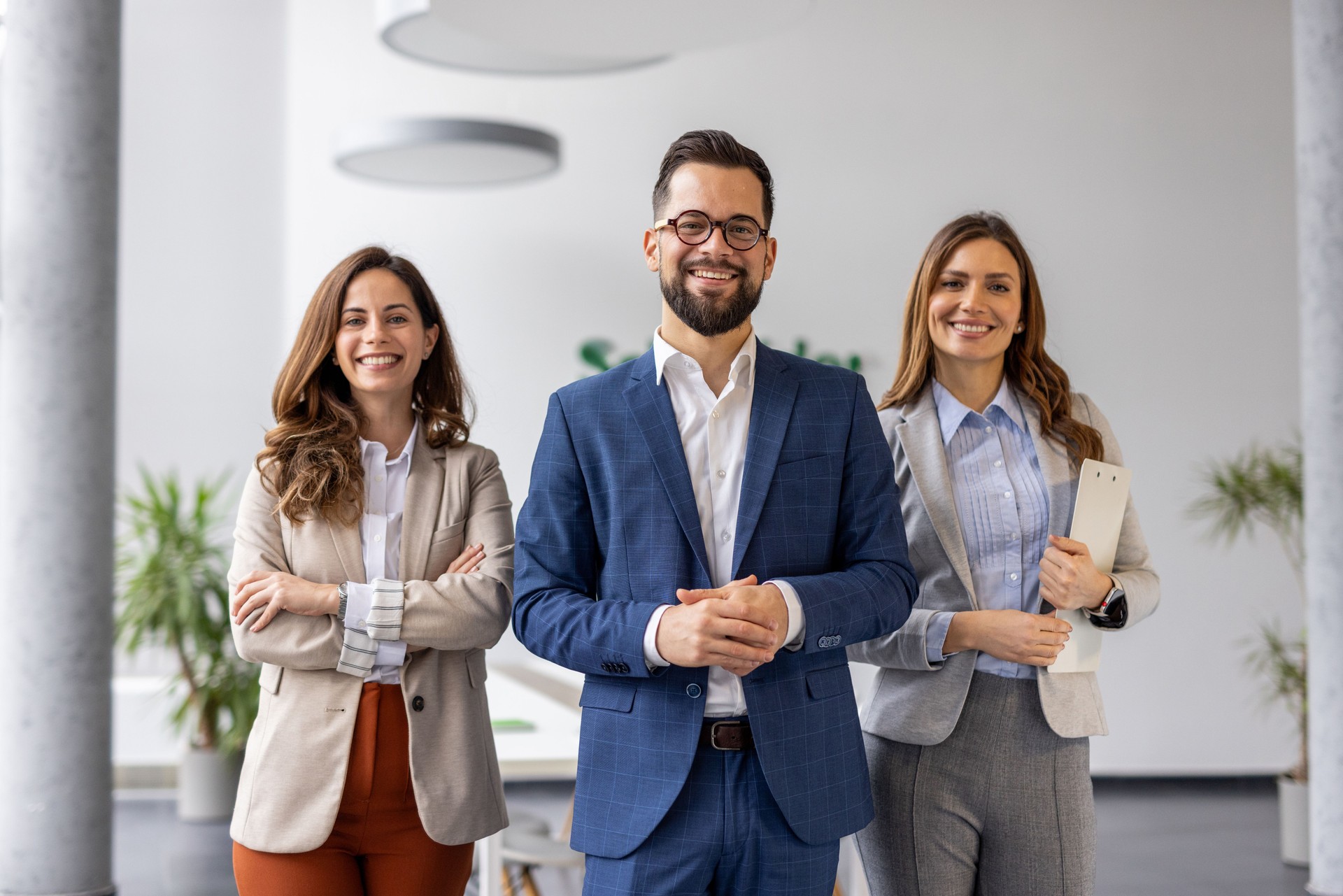 Smiling business team posing together in modern office